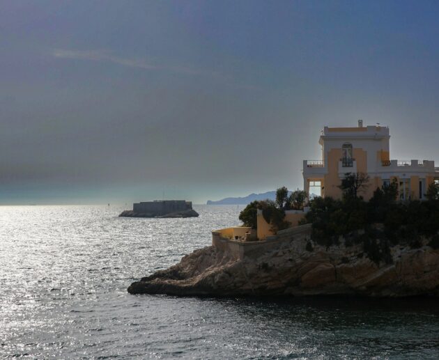 a house on an island in the middle of the ocean