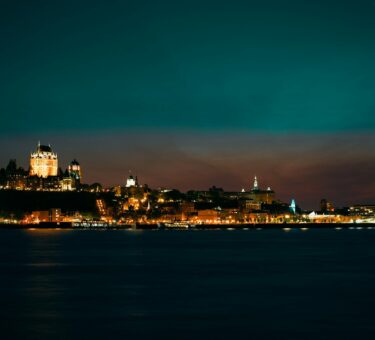 a view of a city at night from the water