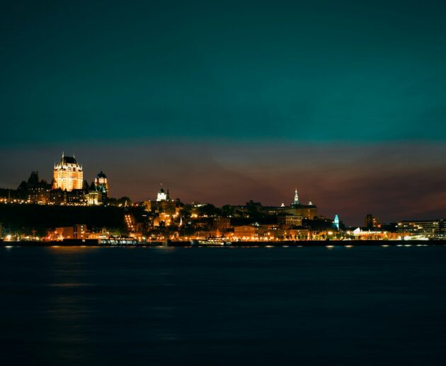 a view of a city at night from the water