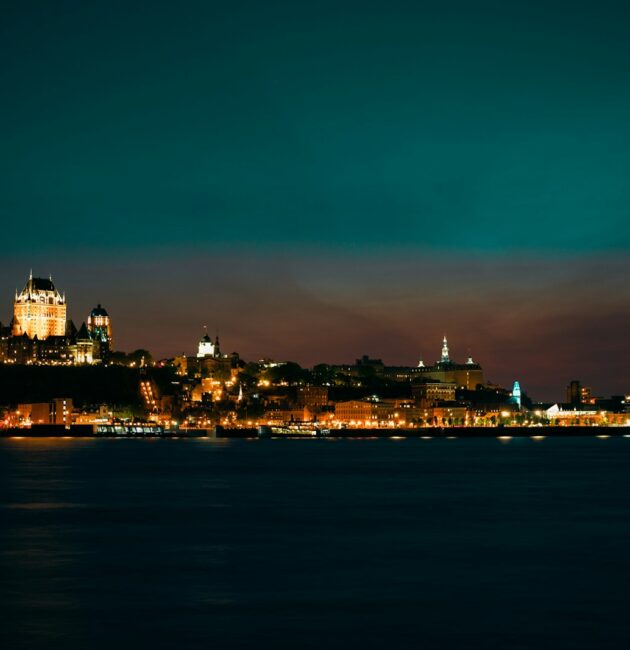 a view of a city at night from the water