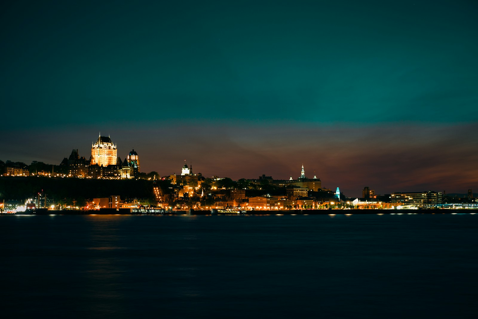 a view of a city at night from the water