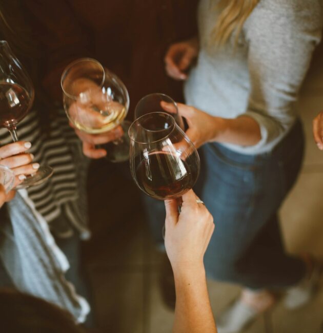 group of people tossing wine glass