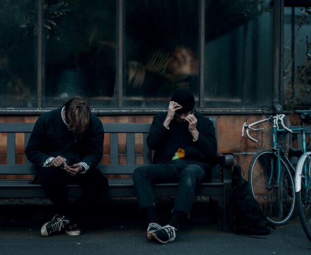 2 women sitting on bench