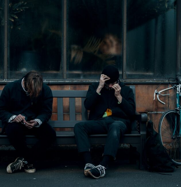 2 women sitting on bench