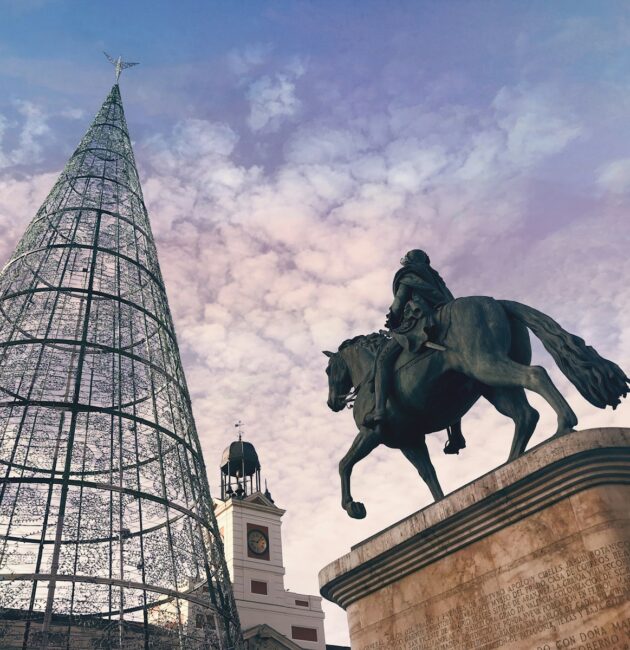 man riding on horse statue near building