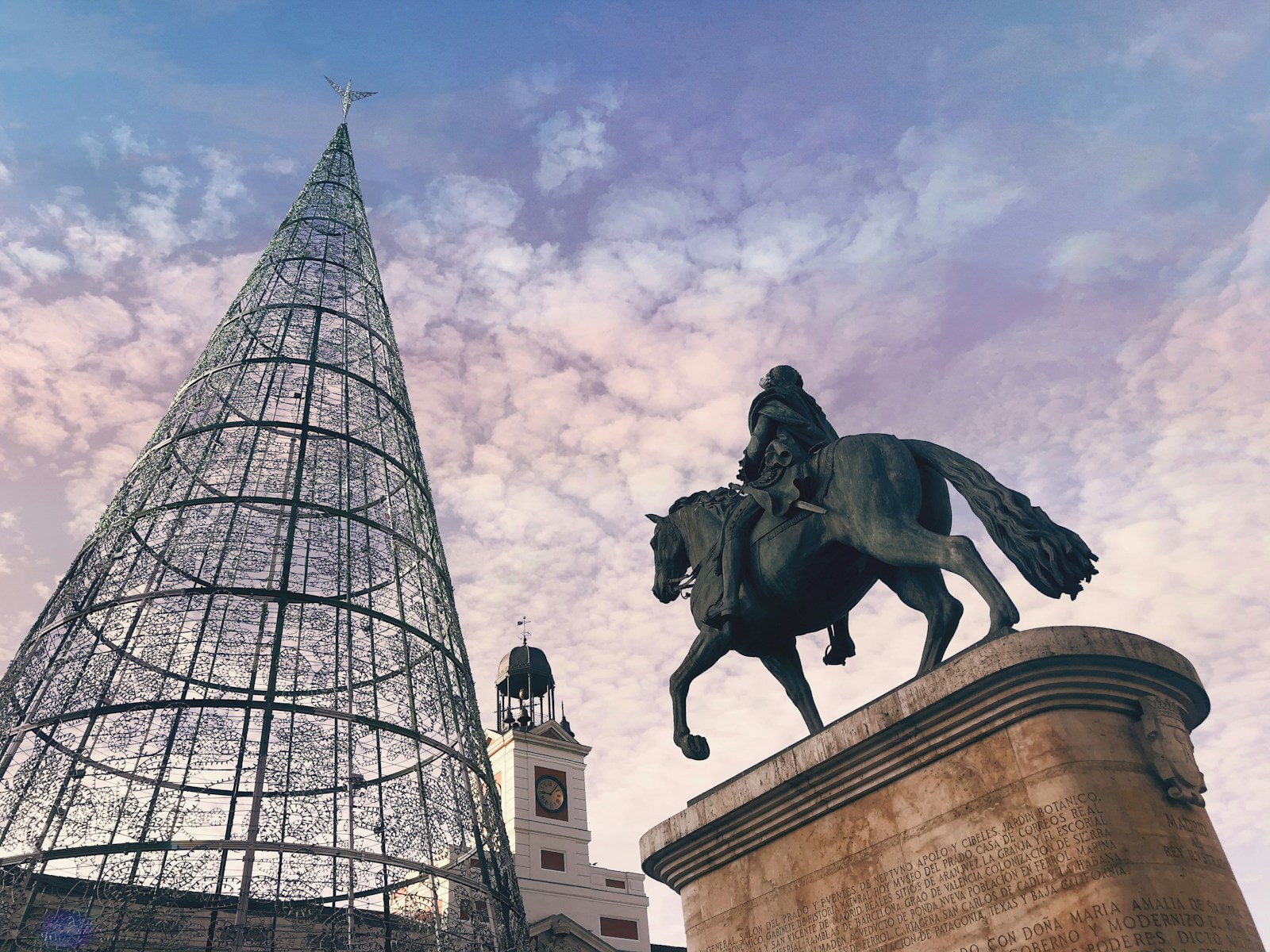 man riding on horse statue near building